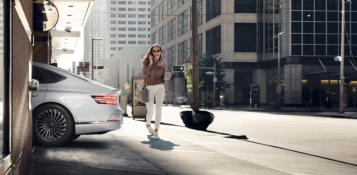 Woman walking behind Electrified G80 