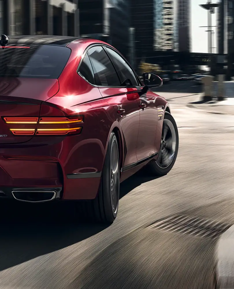 Rear view of red G80 on the road