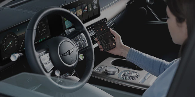 Woman holding smartphone in GV60