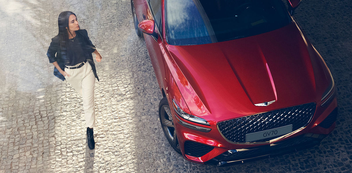 Woman beside red GV70