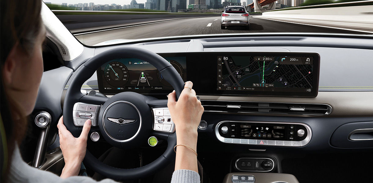 GV60 highway driving assist display with woman driving on highway