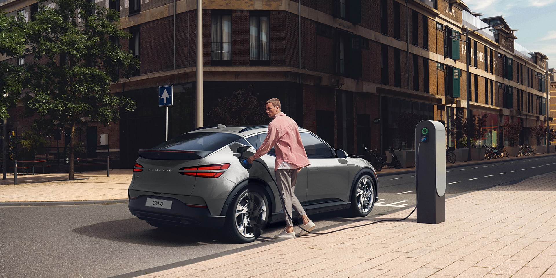 Man charging his GV60 on city street