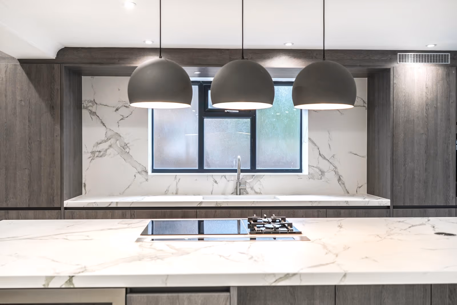 Modern kitchen island view of a Khandys residential development