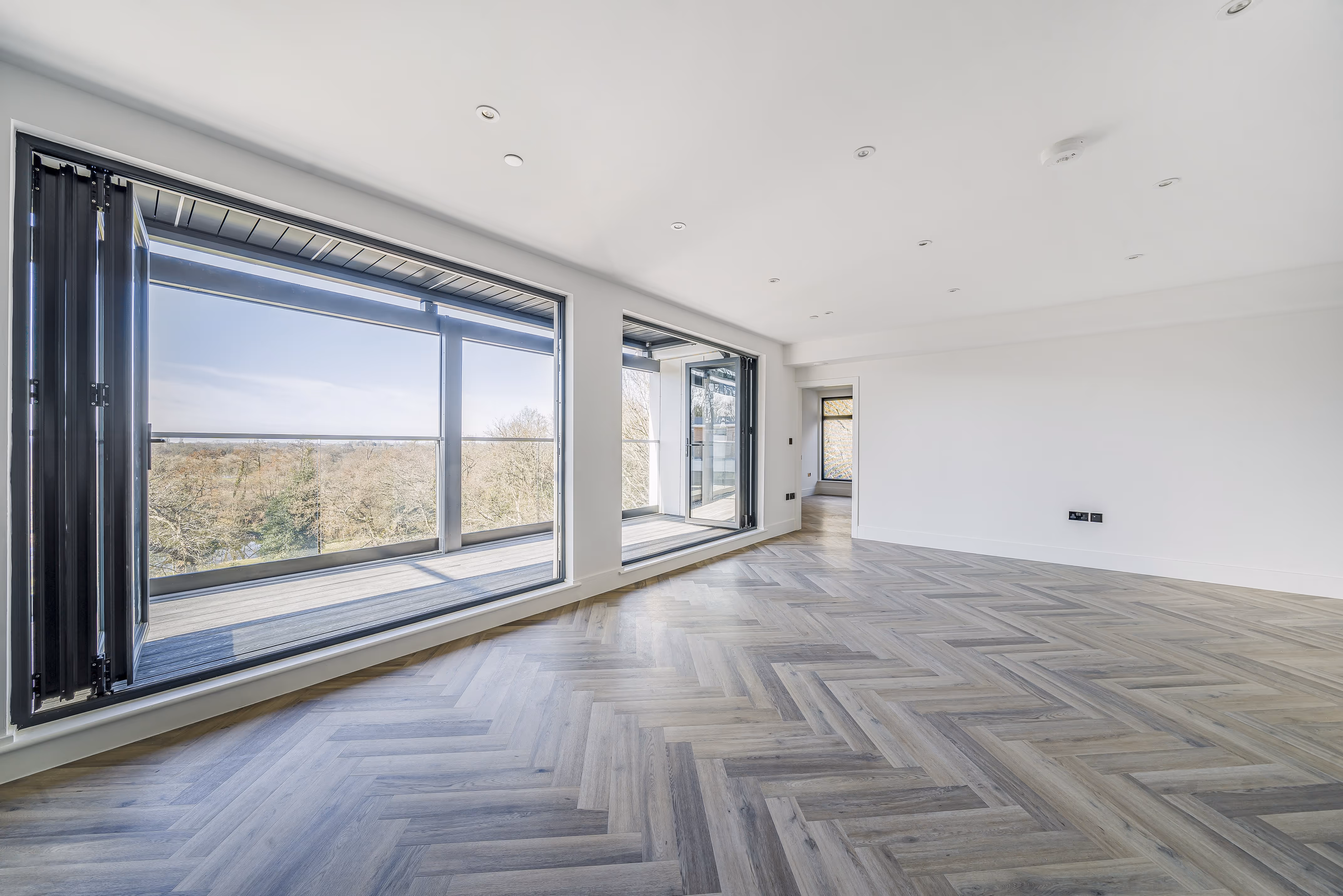 Opened bifold balcony doors from a new flat developed by Khandys