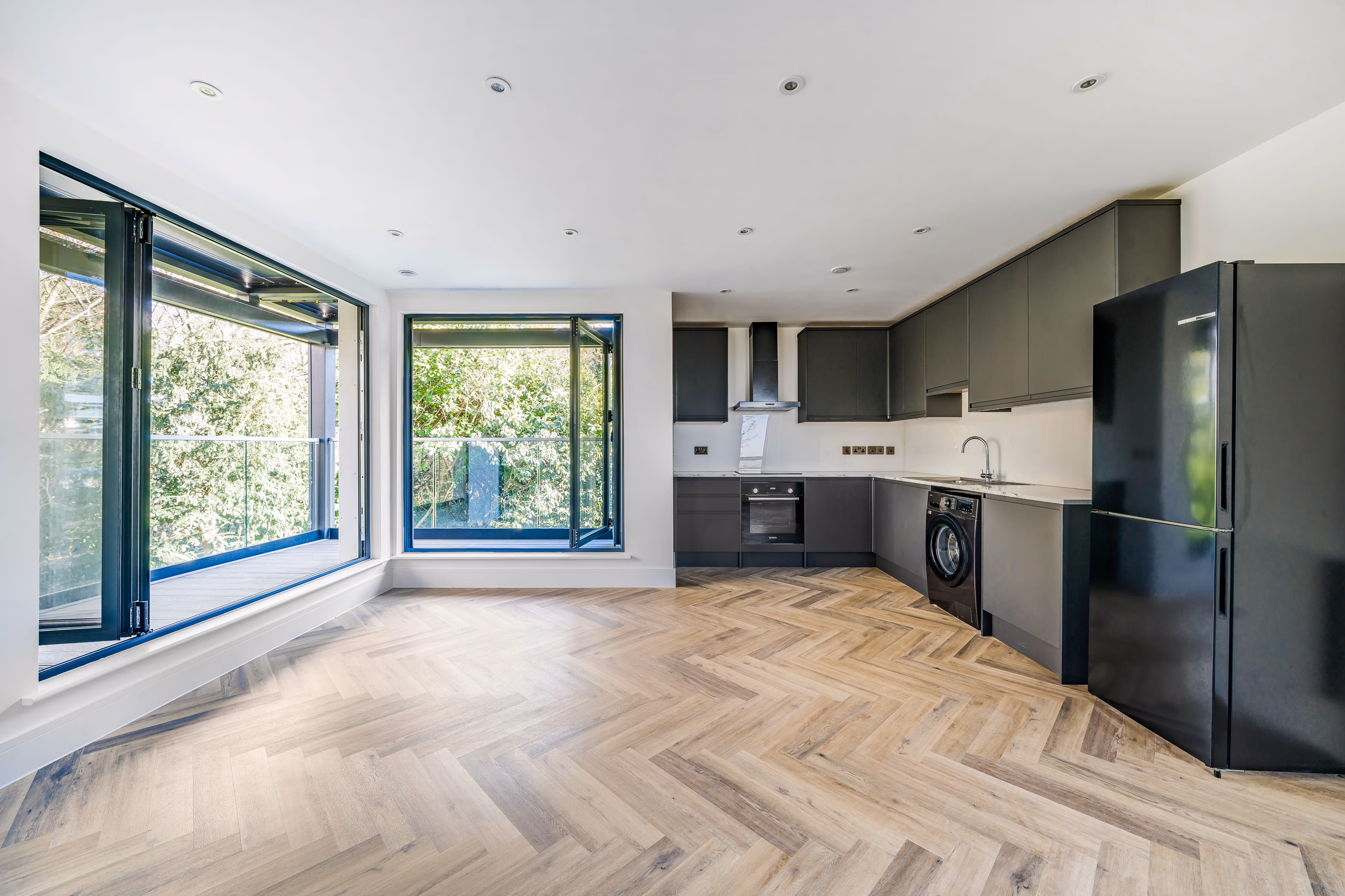 A kitchen/living room area with large bifold doors built by Khandys
