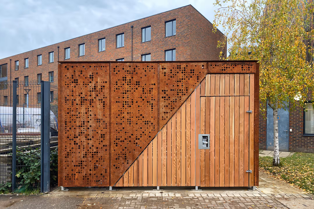 A copper and wood cycle store shot from the front. 