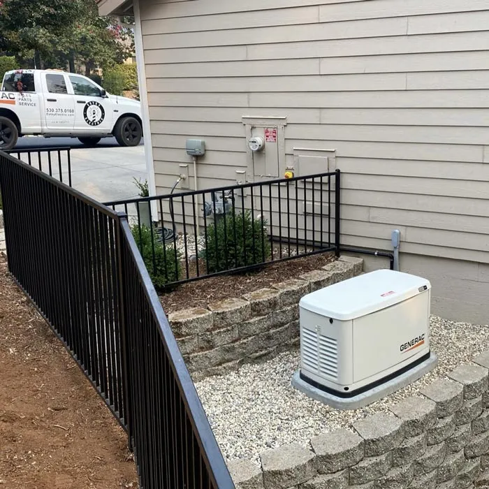 Close-up of a natural gas line feeding the spark plugs and a gas meter, a generator on a concrete pad for all home power needs.