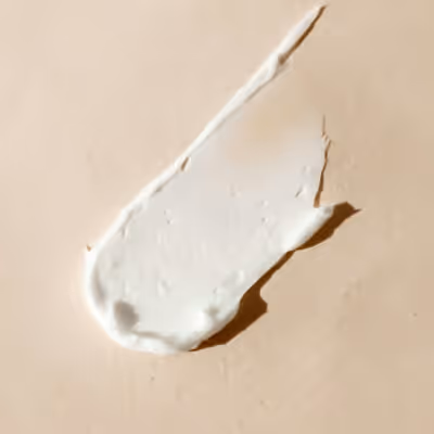 Cosmetic cream swatch on beige background
