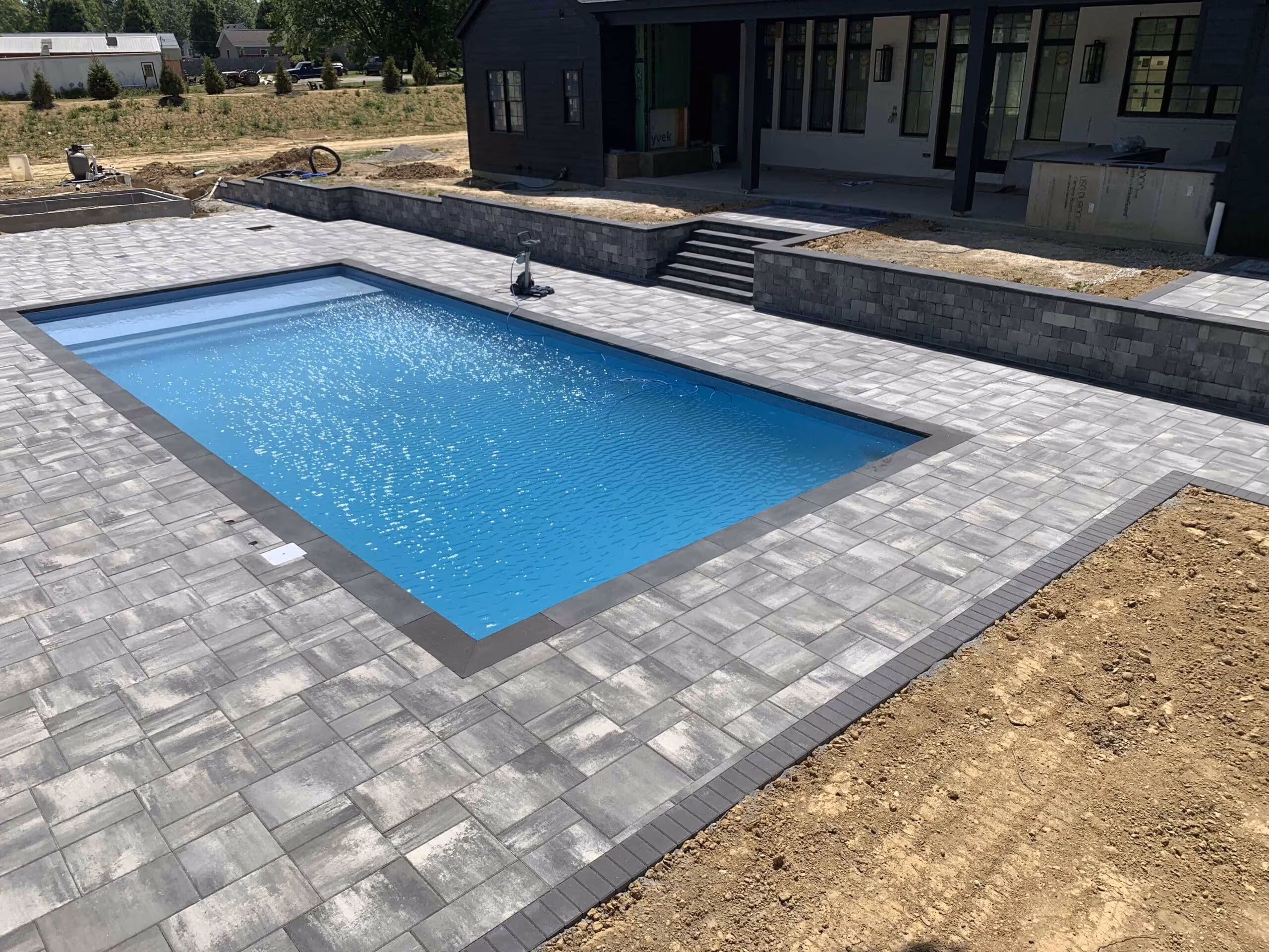 Pool in backyard with new concrete slabs