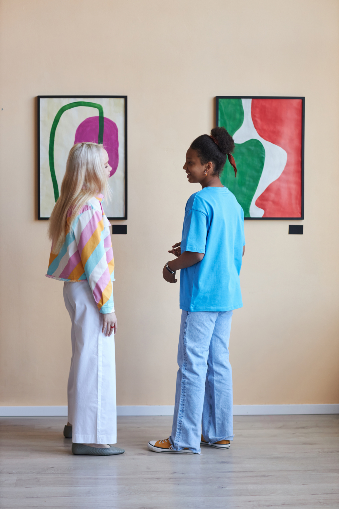 women looking at art stock image