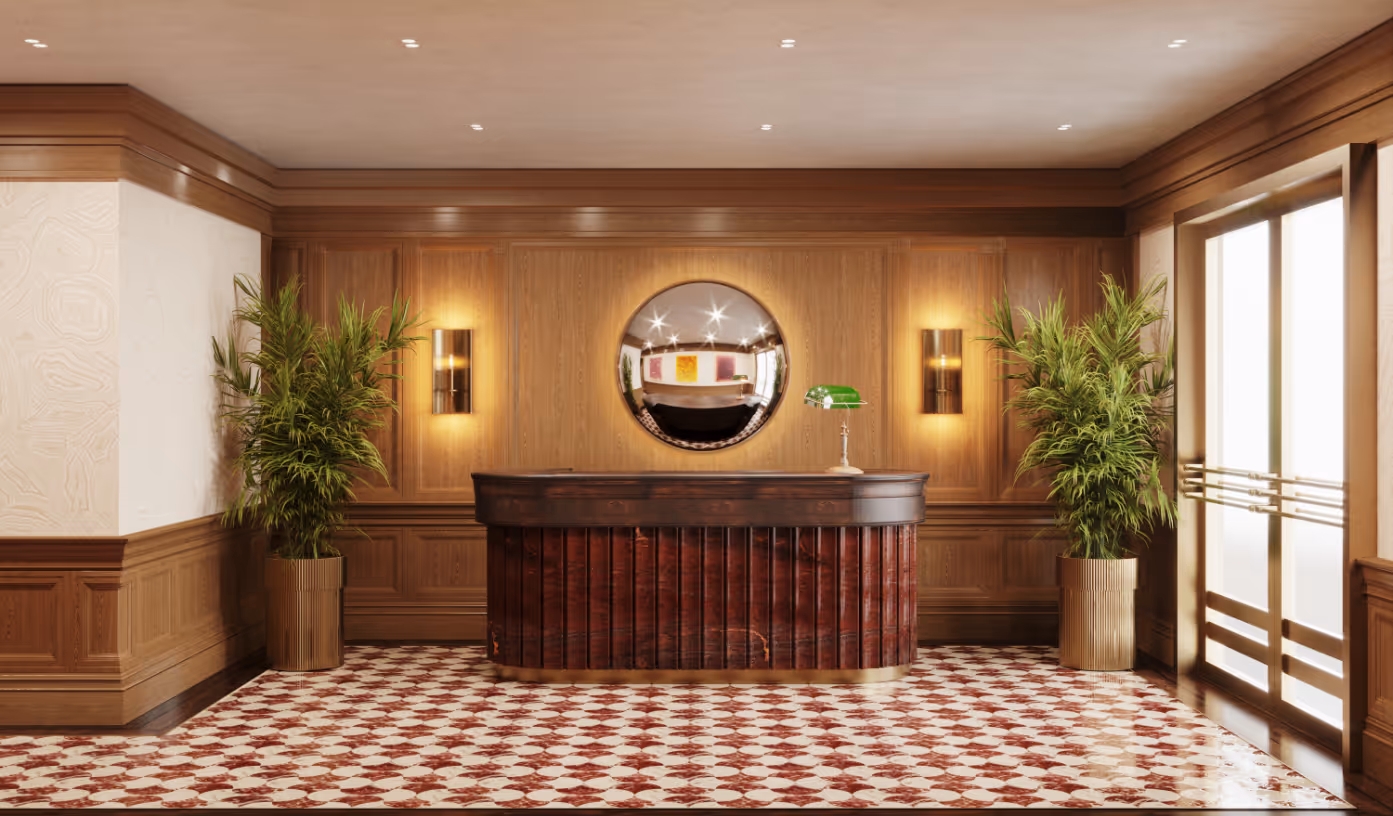 Classic and elegant lobby with a decorative front desk, wood paneling, and a patterned tile floor at Jefferson Arms in St. Louis, MO.