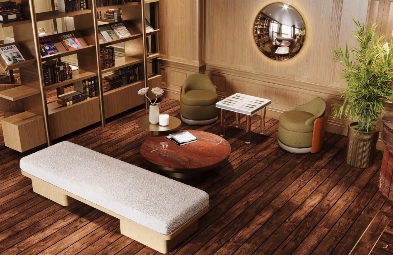 Spacious and well-lit resident lounge with extensive bookshelves, a lounge chair, and a decorative coffee table at Jefferson Arms in St. Louis, MO.