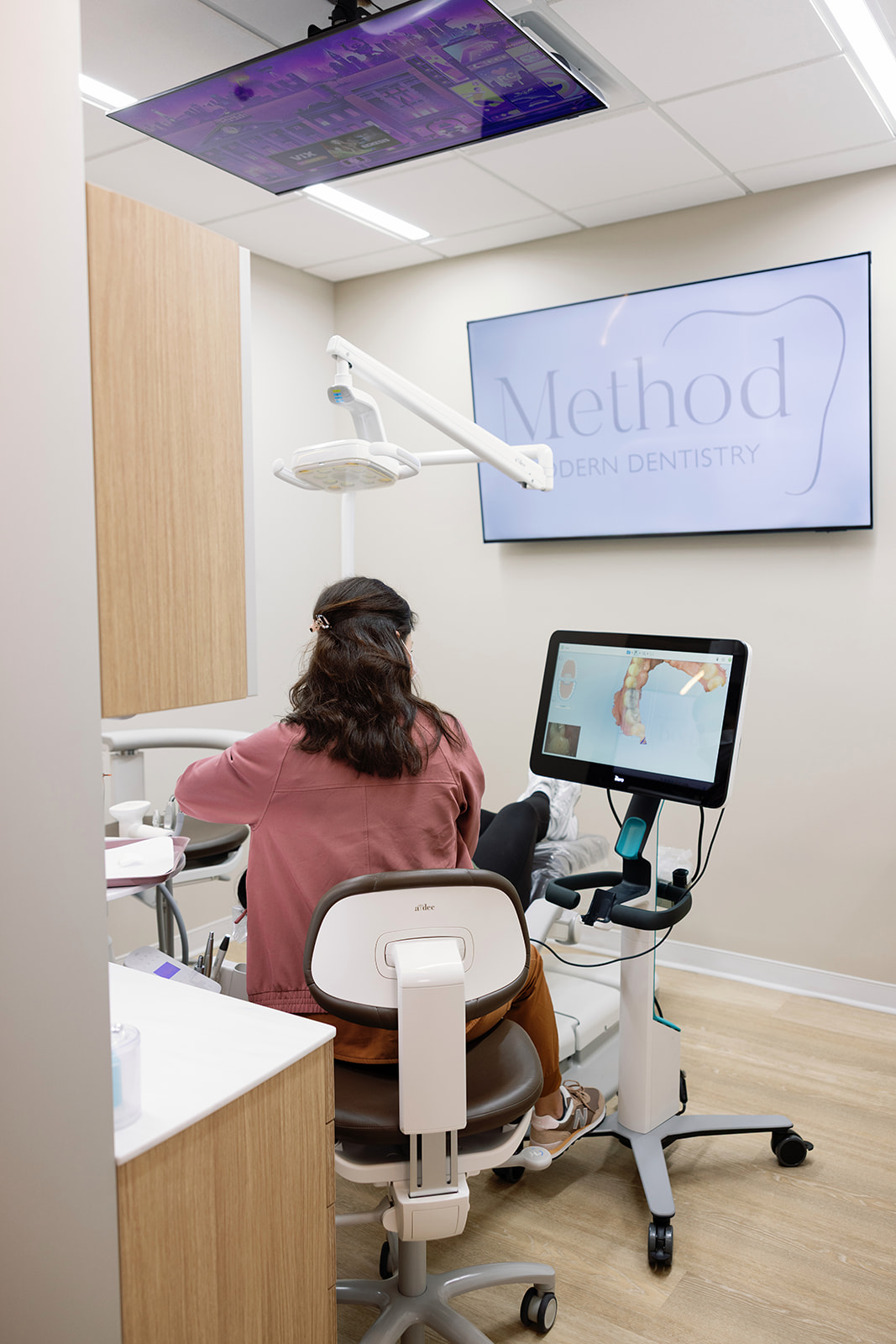 Dr. Alex Franco reviews a digital image of a tooth with a patient before dental treatment.