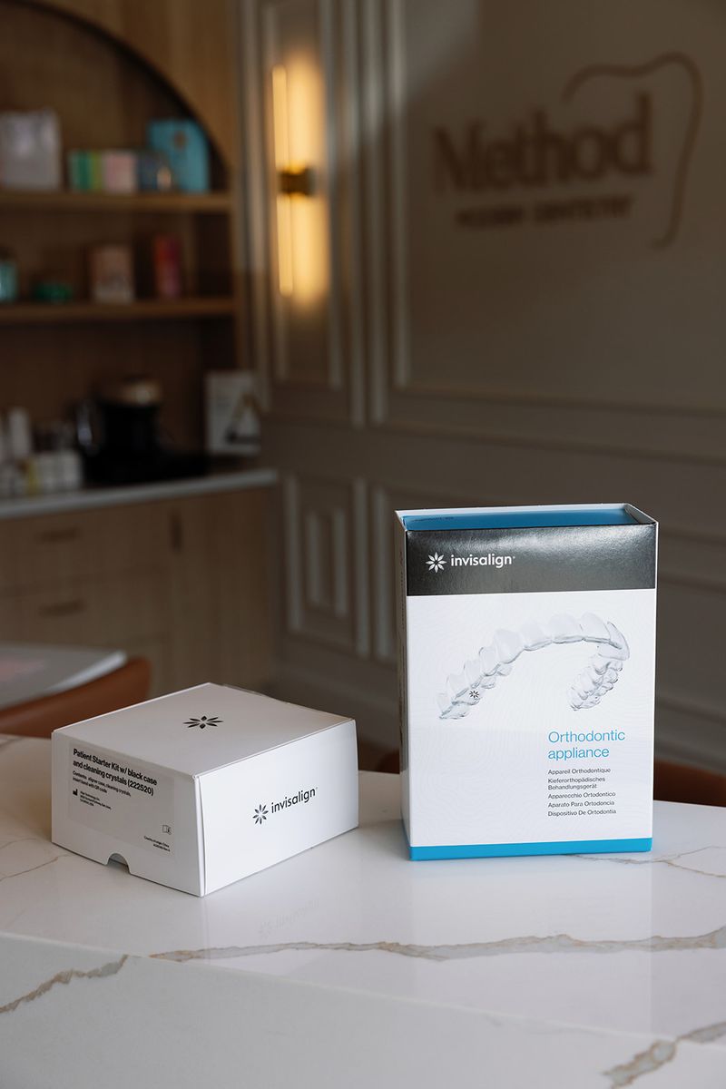 Invisalign clear aligner treatment boxes displayed inside Method Modern Dentistry.