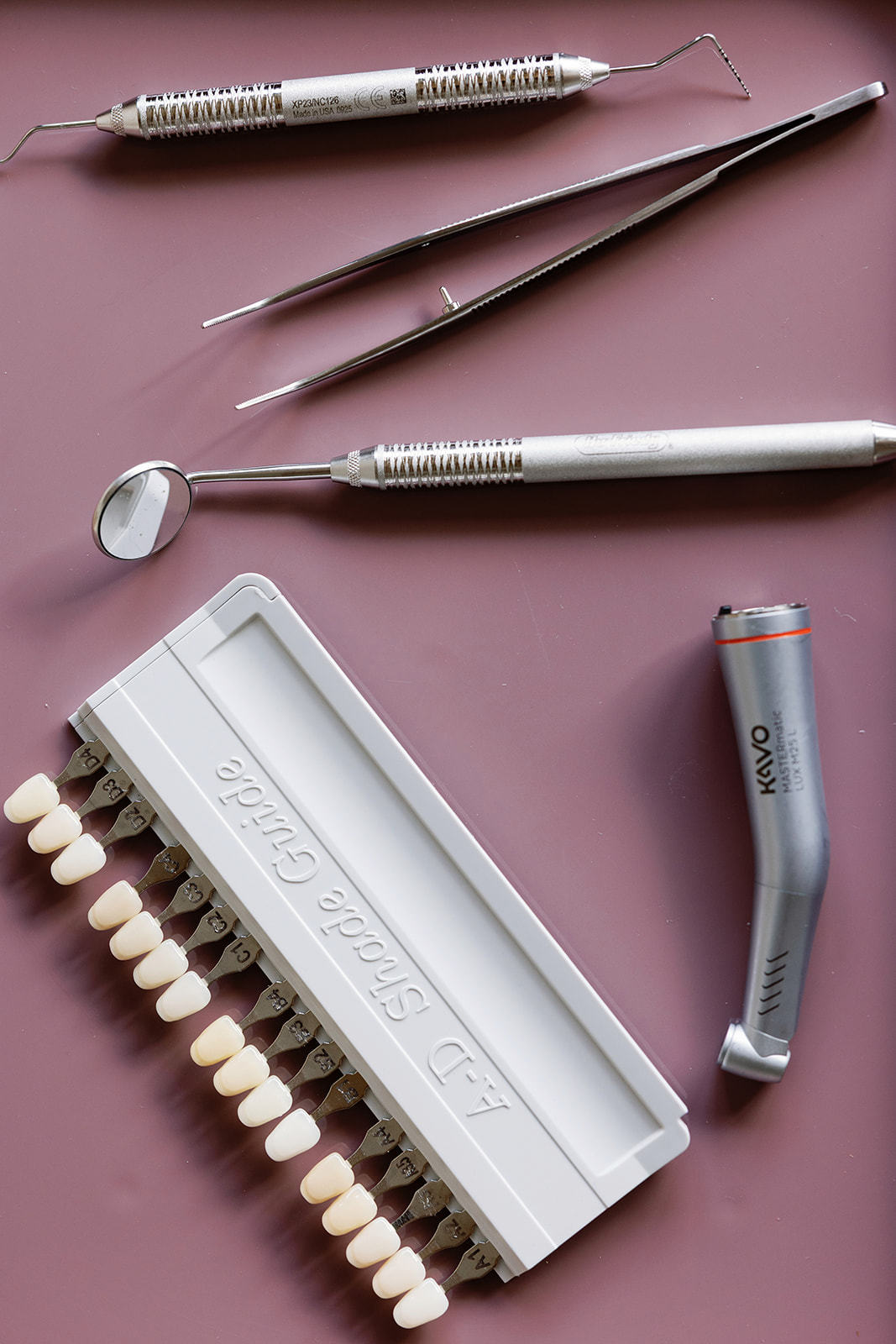 Porcelain veneer shade guide displayed with dental examination tools.