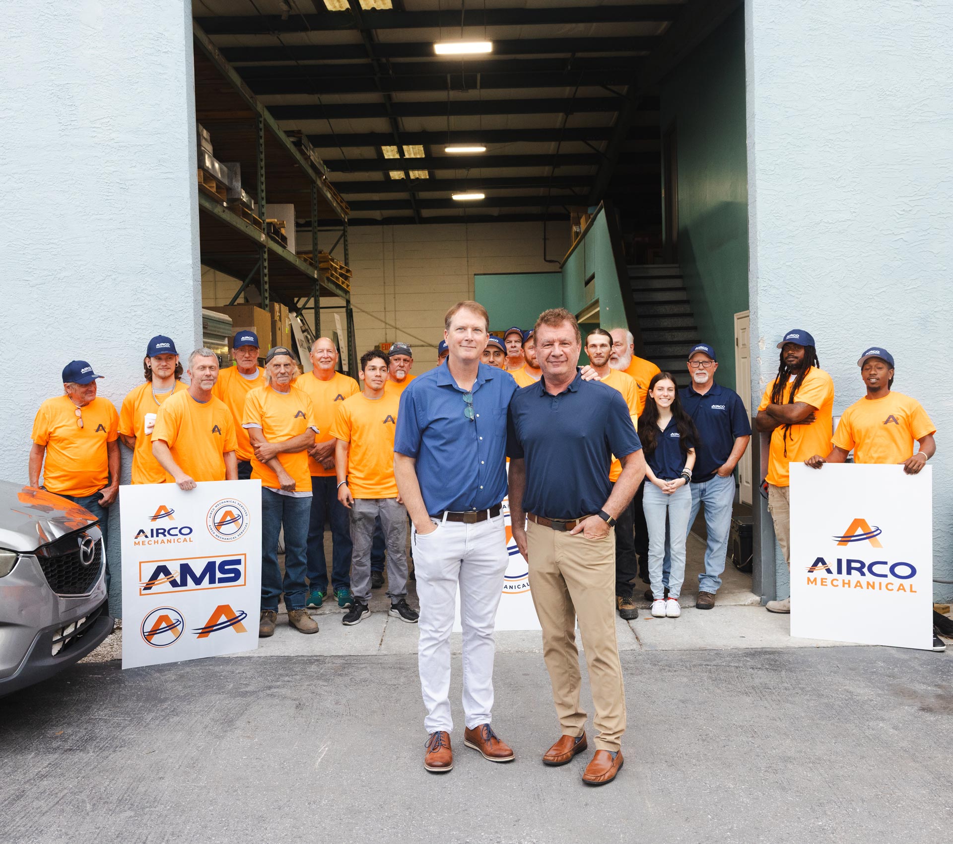 Airco Mechanical Services leadership team with staff outside company headquarters in Largo, Florida