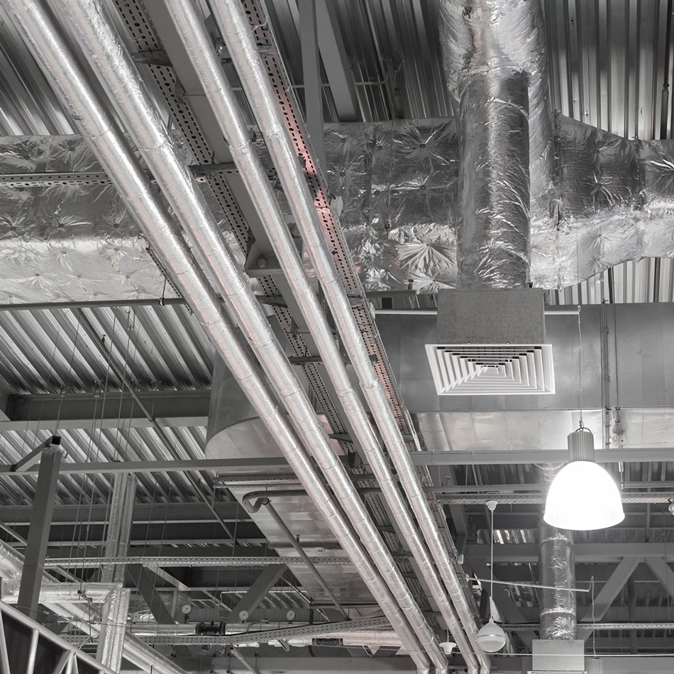 Exposed commercial HVAC ductwork and ventilation system in industrial building