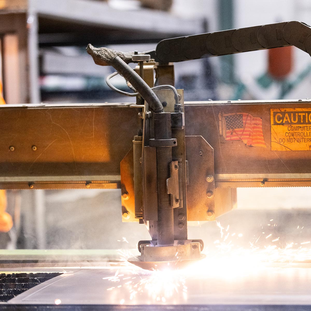 Close-up of machine cutting metal with sparks flying