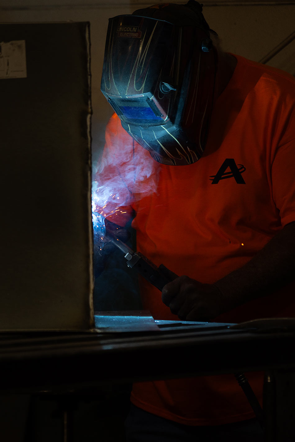 Airco Mechanical Services technician welding sheet metal for commercial HVAC fabrication