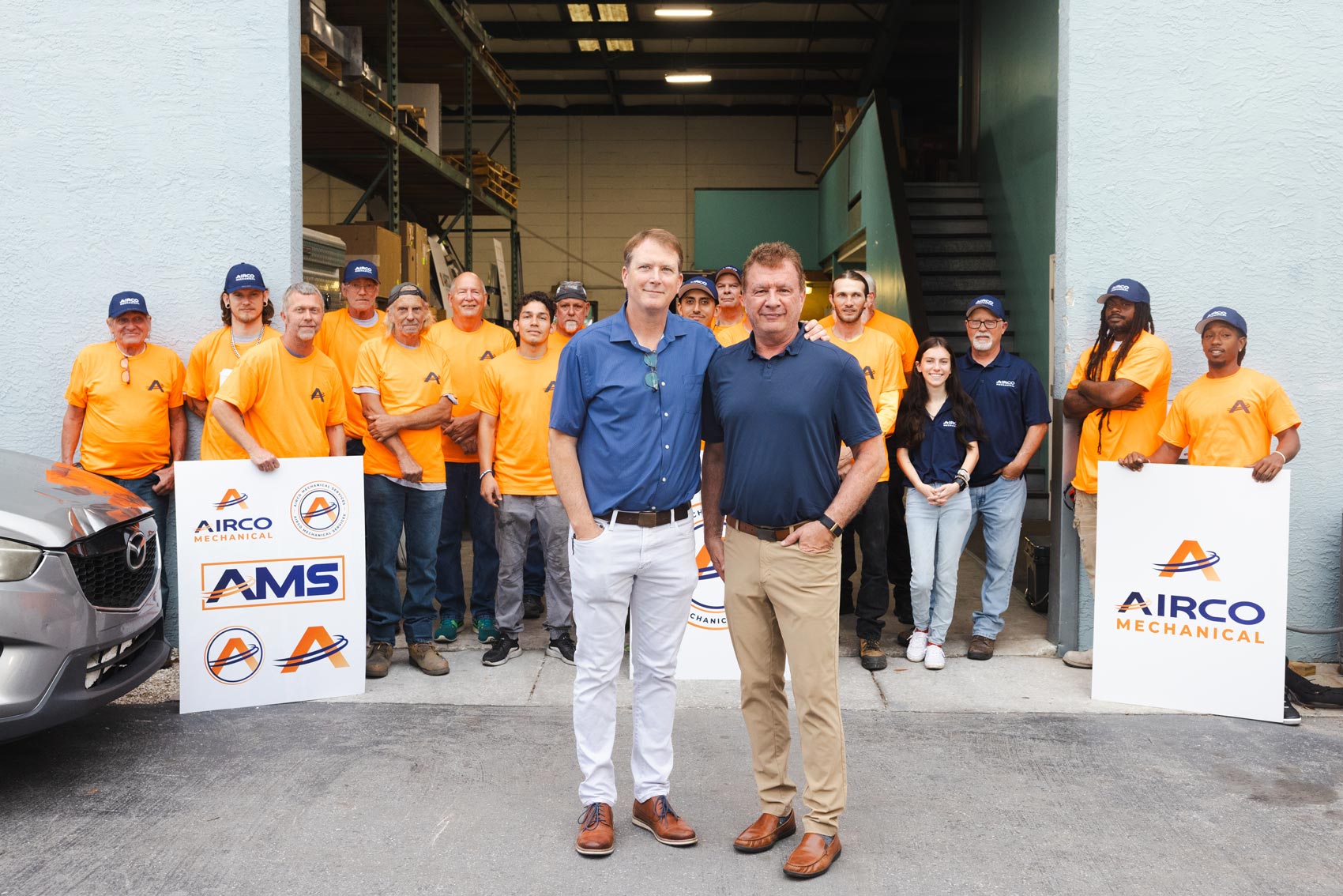 Airco Mechanical Services leadership team with staff outside company headquarters in Largo, Florida