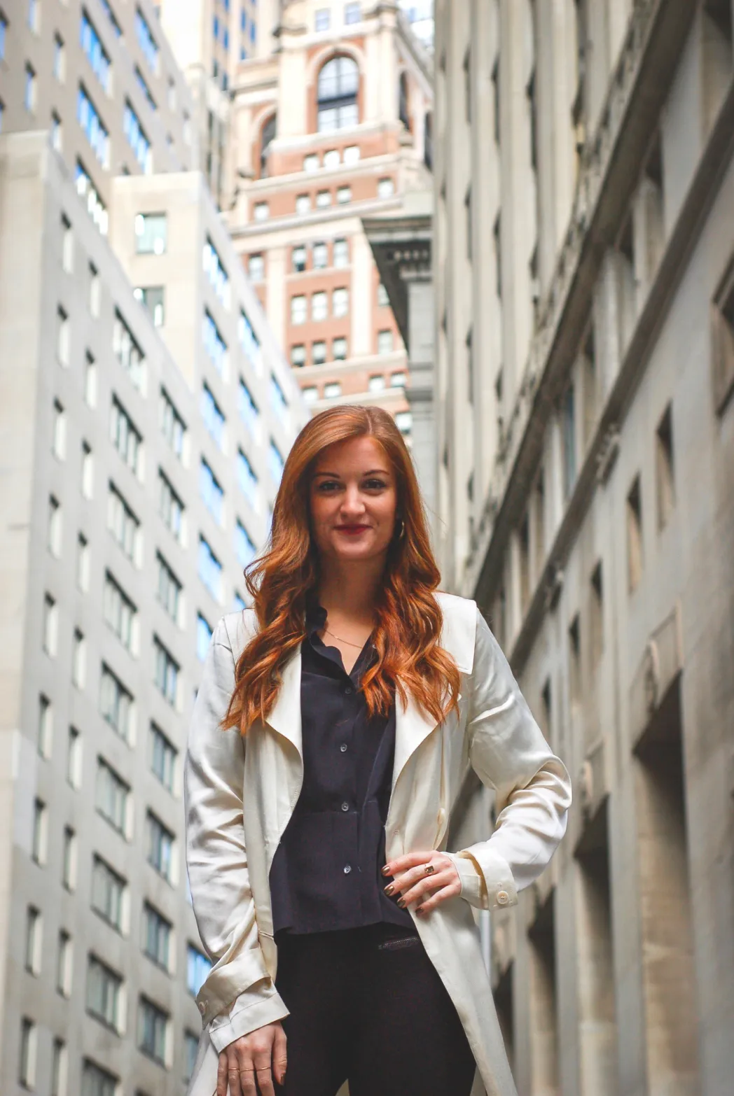Woman wearing formal clothes between office buildings