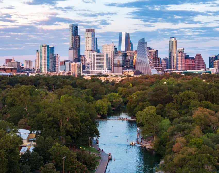 Austin, Texas skyline above Barton Springs Pool and surrounding park trees