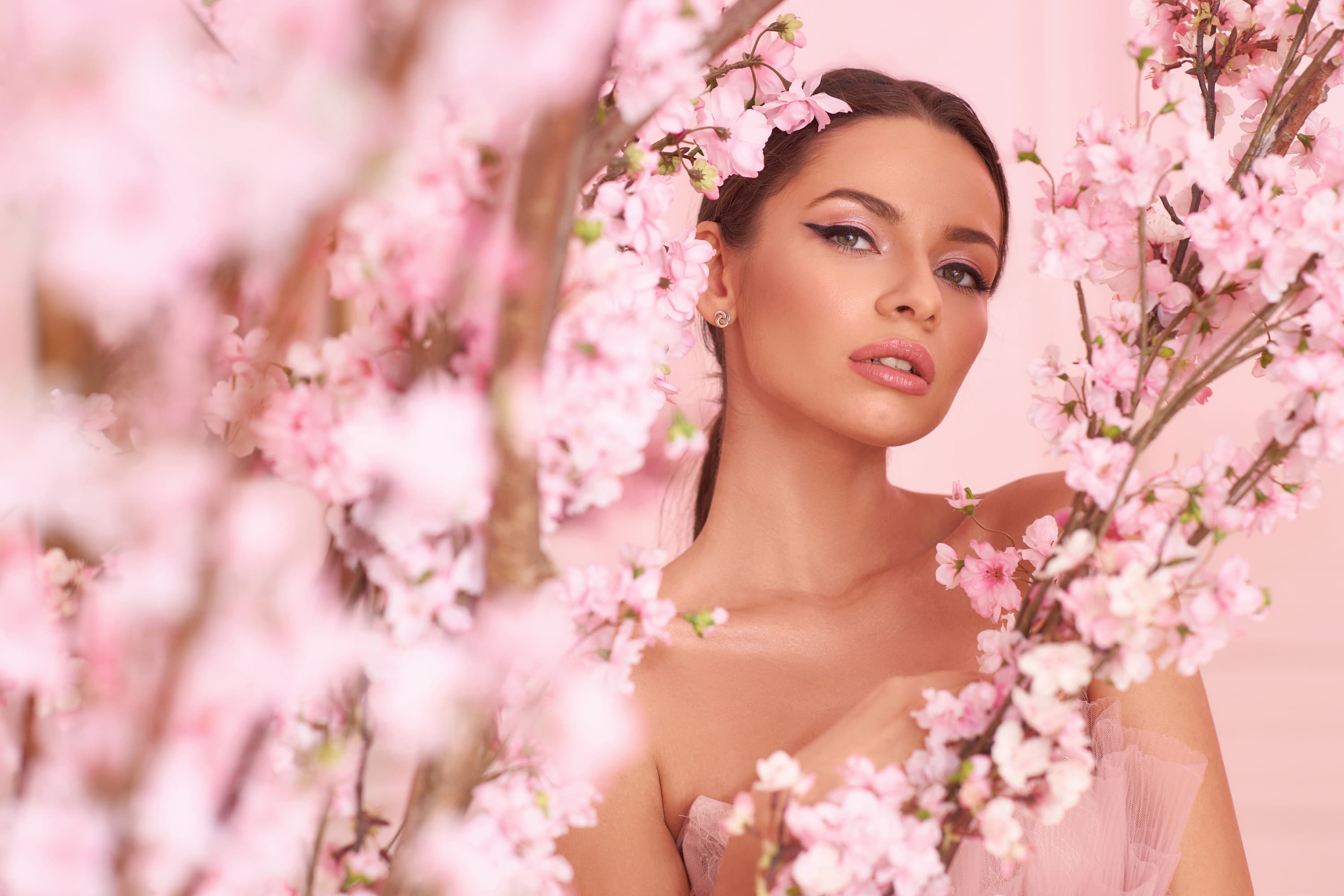 feminine woman surrounded by cherry blossoms