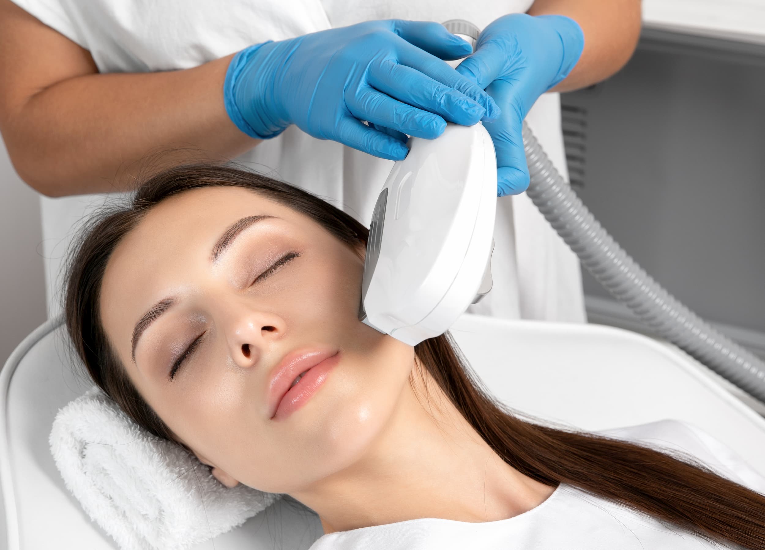 woman receiving laser treatment on face