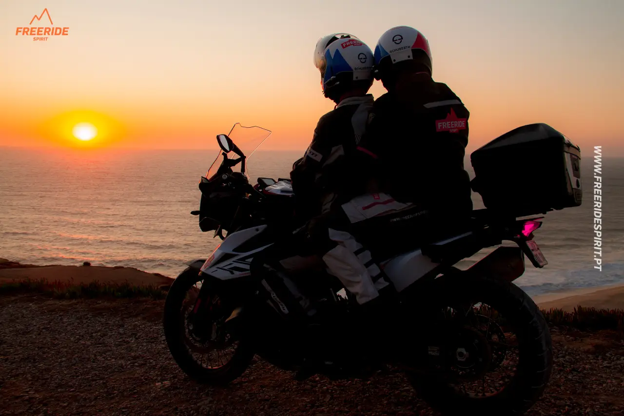 Rider and his passenger enjoying the ocean view and sunset