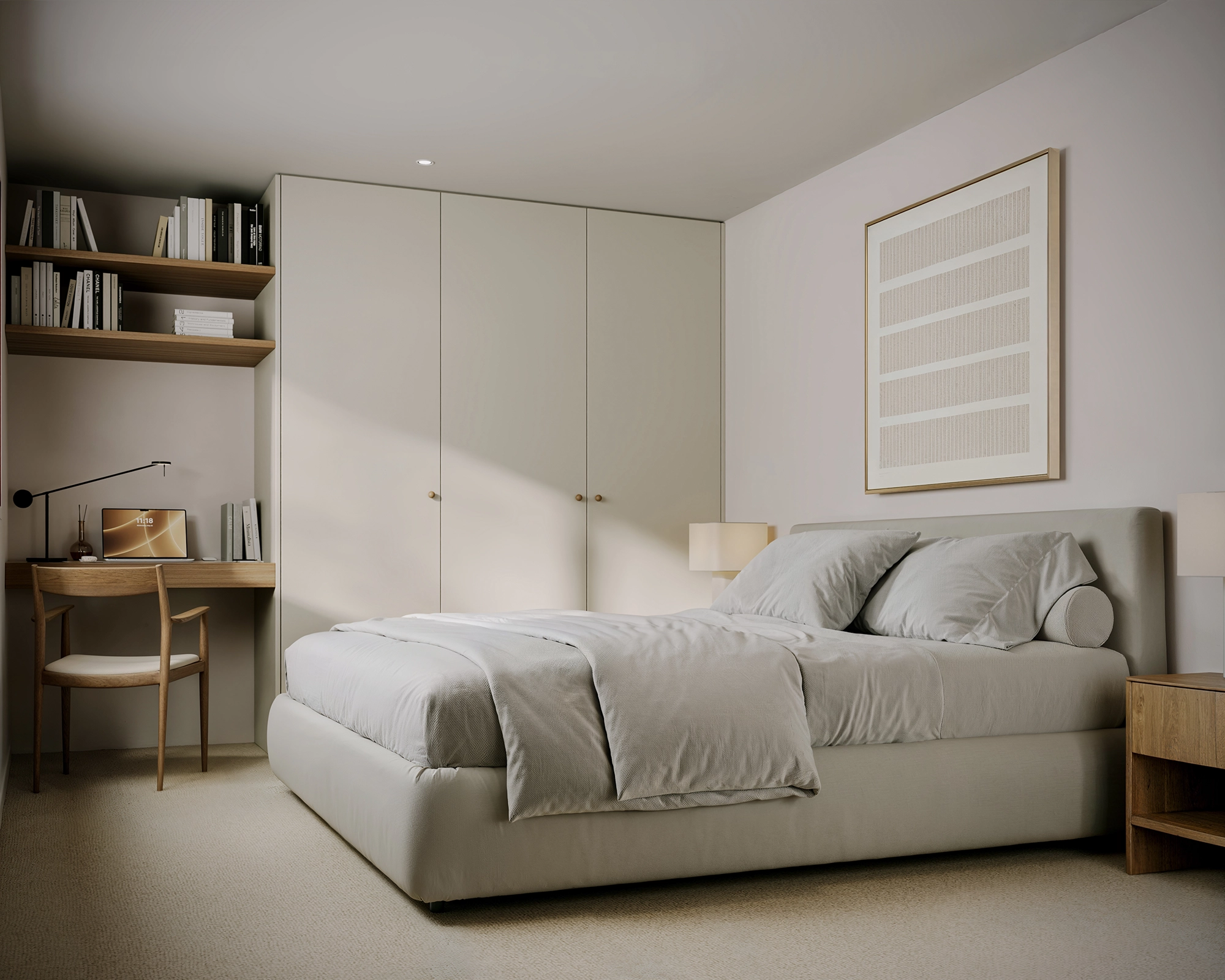 Minimalist bedroom with beige upholstered bed, wooden desk, shelves with books, and closet.
