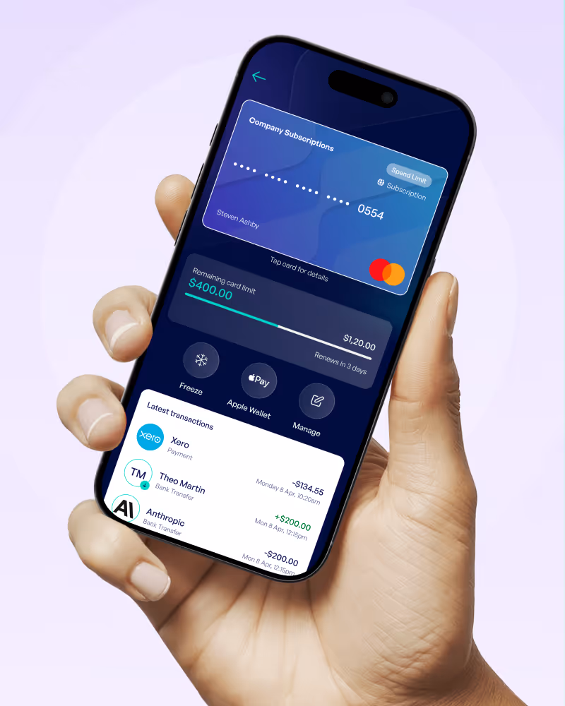 Hand holding a smartphone displaying a digital company subscription card with remaining card limit of $400 and recent transactions.