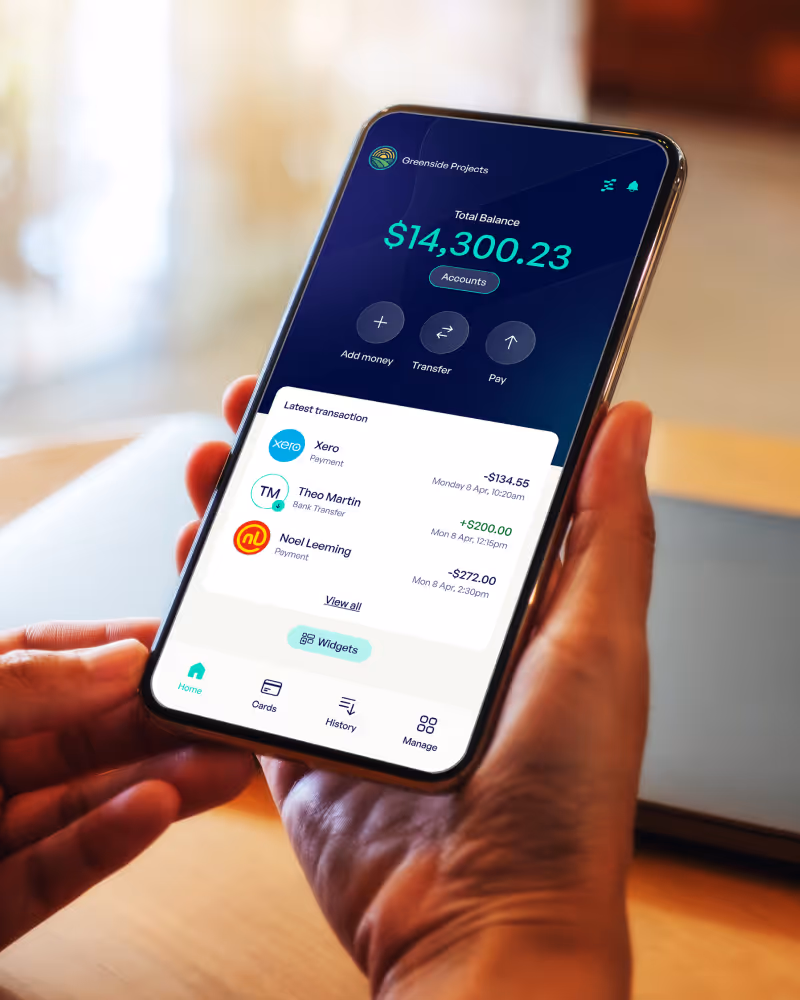 Smartphone showing a banking app with a total balance of $14,300.23, buttons to add money, transfer, and pay, and a list of recent transactions.
