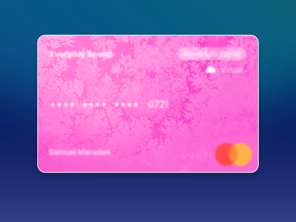 Pink Mastercard credit card with frost pattern overlay and blurred text on a blue gradient background.
