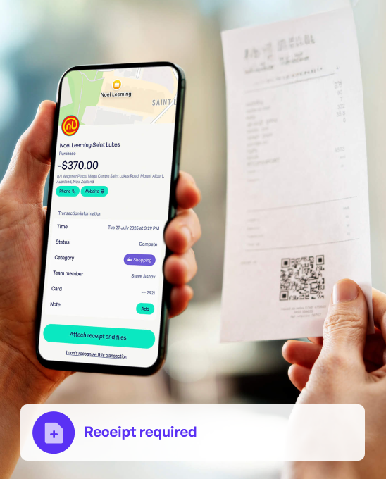 Person holding a phone showing a $370 purchase at Noel Leeming Saint Lukes with details and an option to attach receipt, while the other hand holds a corresponding printed receipt.