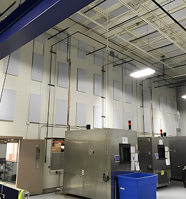 Inside of a factory with acoustic pads on the walls.