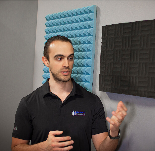 A man staring at an acoustic pad.
