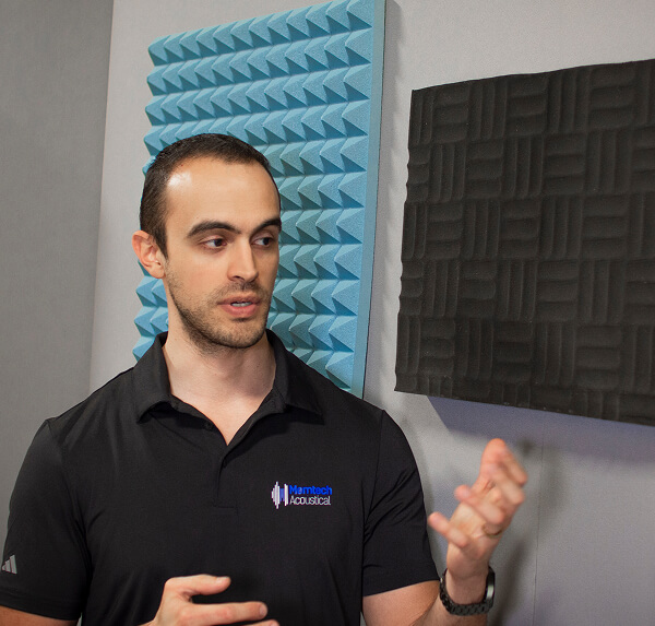 A man staring at an acoustic pad.