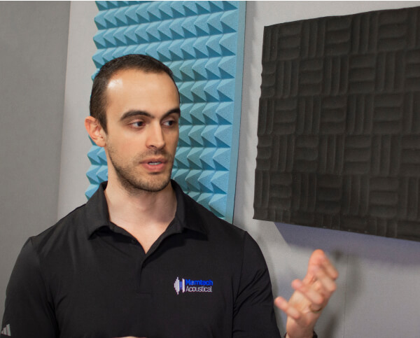 A man staring at an acoustic pad.