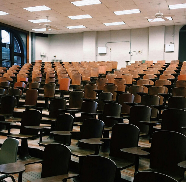 A classroom with plenty of chairs.