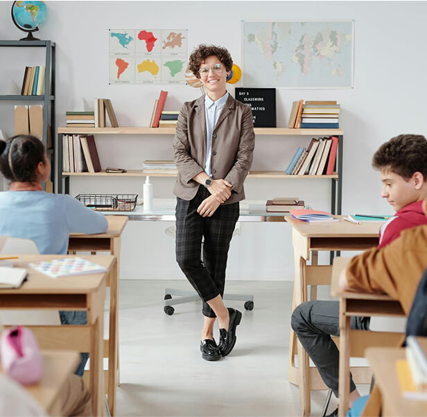 A teacher standing on the middle staring at the elementary kids.