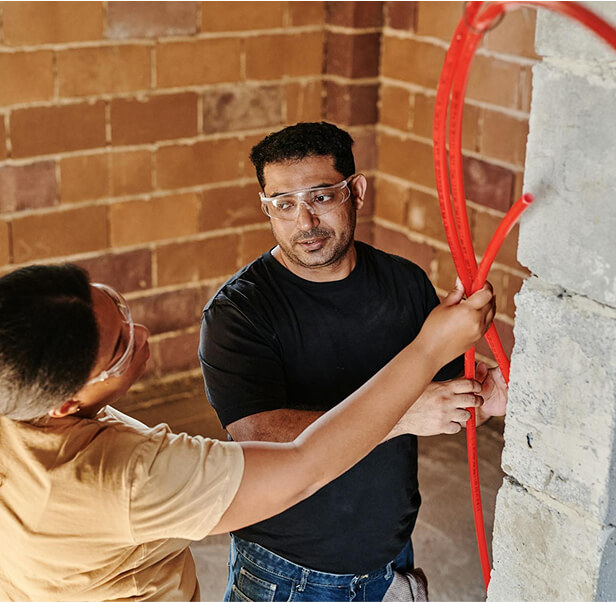 Two workers doing electrical installation.