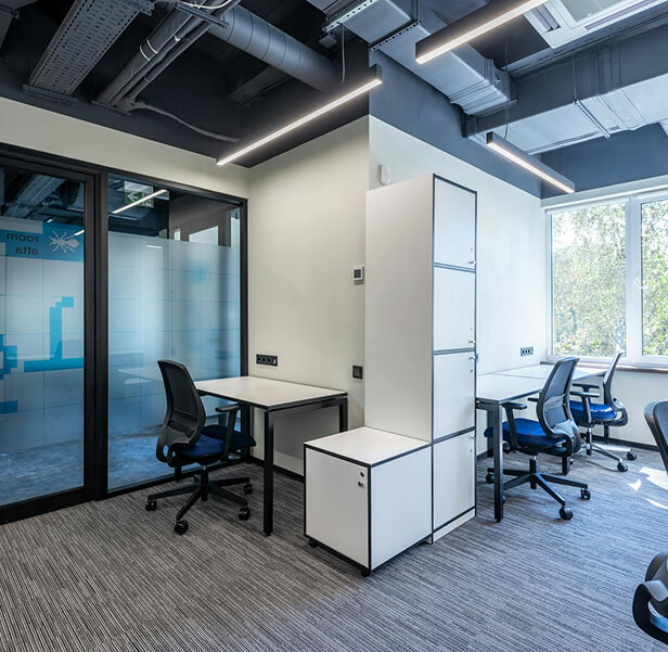 An office room with white walls and drawers.