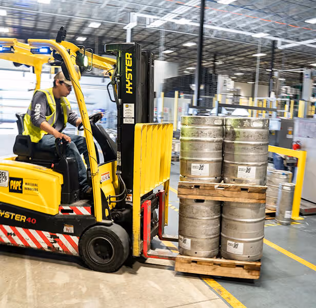 A man operating a tow tractor.
