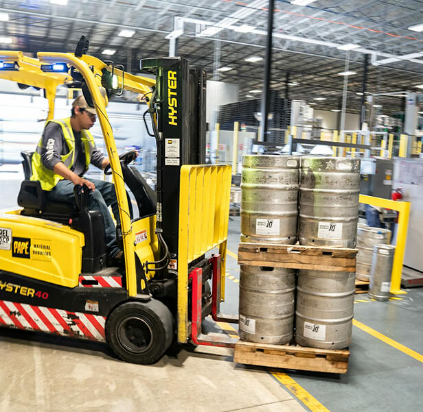 A man operating a tow tractor.
