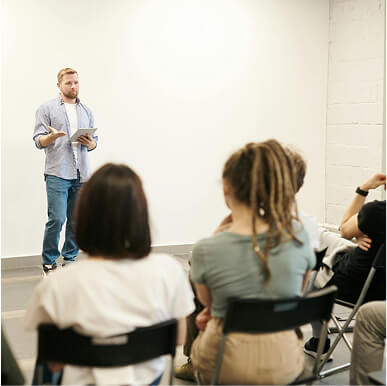 A man giving a lecture in front of people.