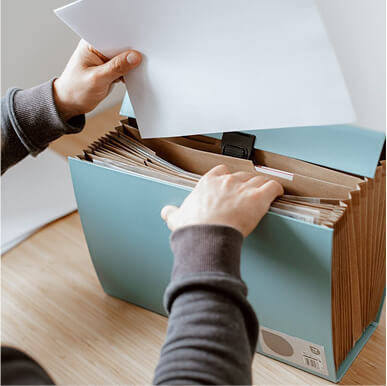 A man sorting out documents in an envelope.