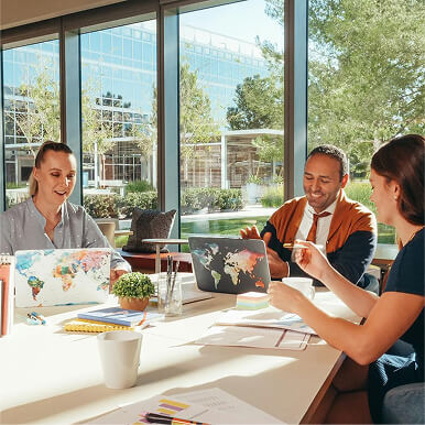 People meeting around a table inside the conference room with glassy windows.