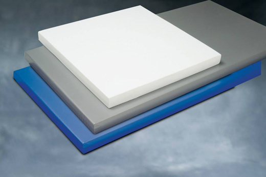 Stack of colorful acoustic foam panels in white, gray, and blue—used for sound absorption in various architectural and industrial environments.