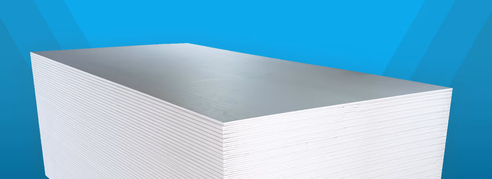 Stack of white drywall sheets against a blue gradient background.