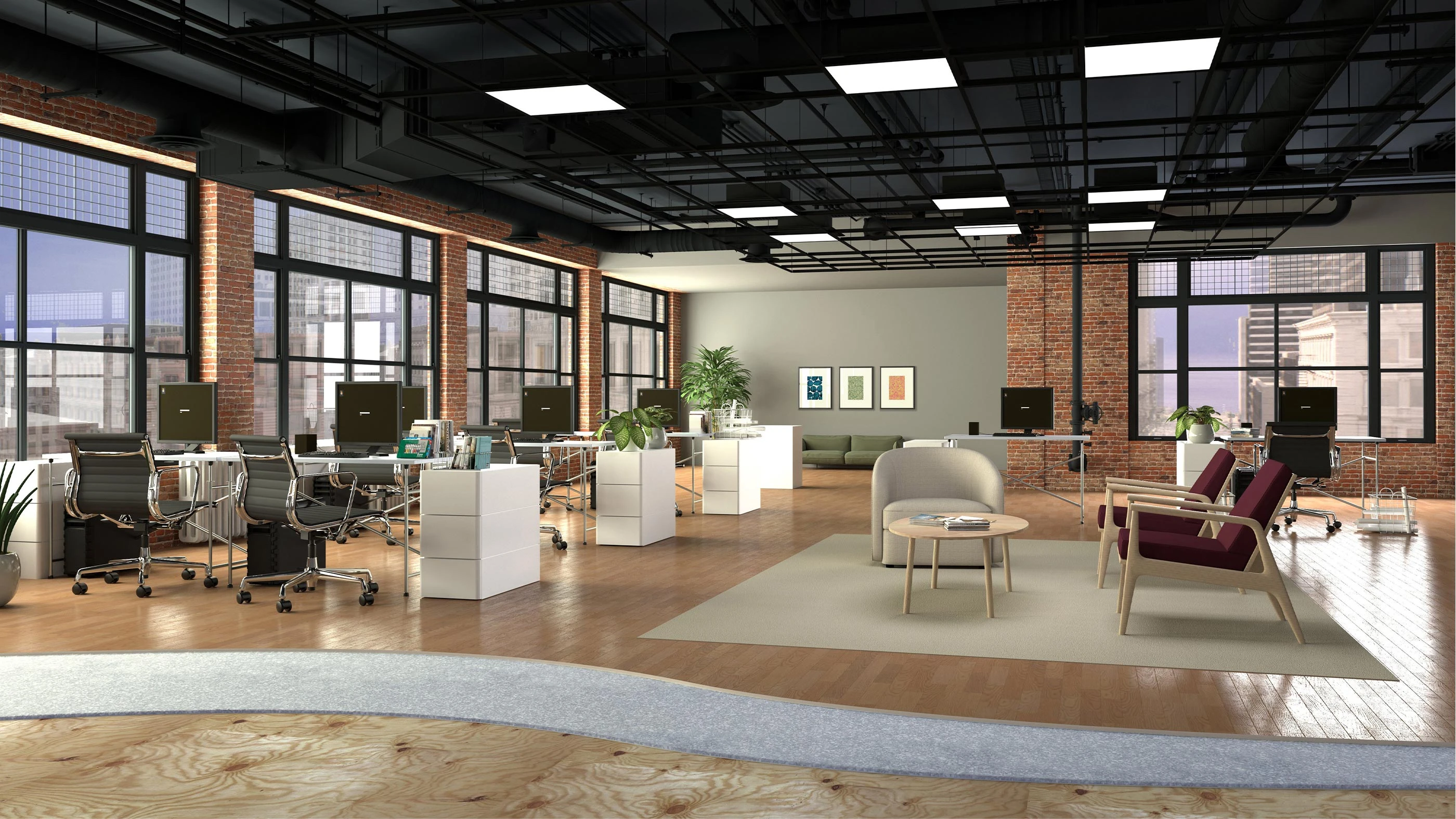 Modern open office with wooden floors, multiple desks with computers, black office chairs, large windows, and a seating area with armchairs and a sofa.